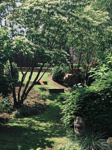 a park with a path and trees and a bench at Le voyage d'UBUNTU in Heiligenstein