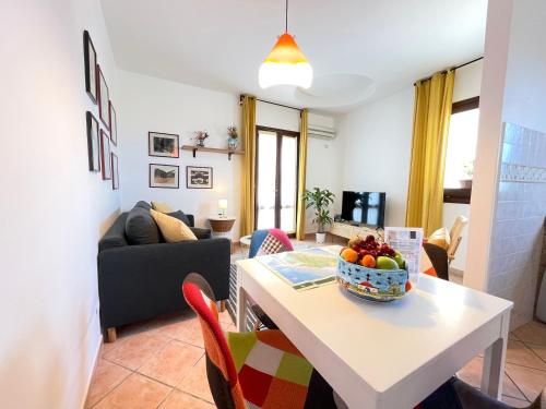 a living room with a table with a bowl of fruit on it at La Casetta di Pantelleria in Pantelleria