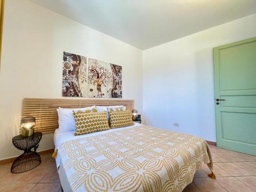 a bedroom with a bed and a blue door at La Casetta di Pantelleria in Pantelleria