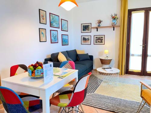 a living room with a couch and a table and chairs at La Casetta di Pantelleria in Pantelleria