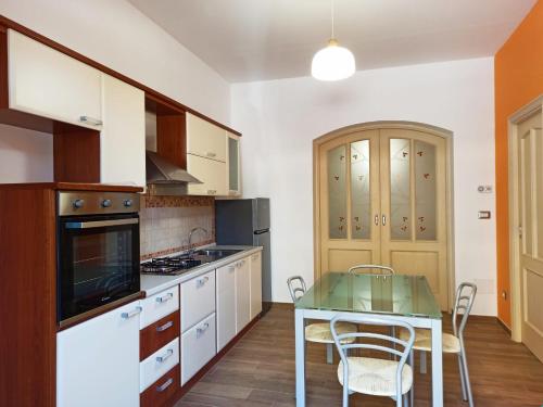 a kitchen with a table and a dining room at A Casitta in Furnari