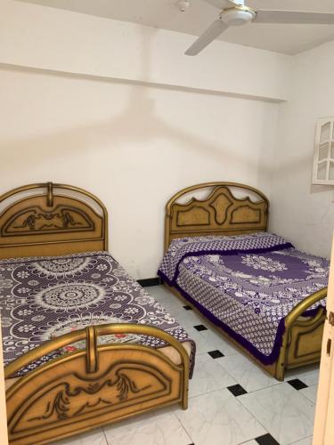 two beds sitting next to each other in a room at Ashour Tower Ramy Abdulla For Families only in Marsa Matruh