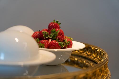 a bowl of strawberries on top of a table at PICCOLA MAESTA' boutique rooms in Civitanova Marche