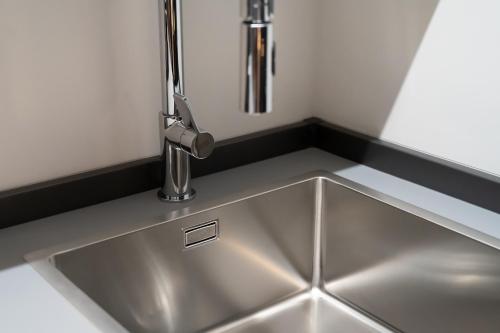 a sink in a kitchen with a faucet at PICCOLA MAESTA' boutique rooms in Civitanova Marche
