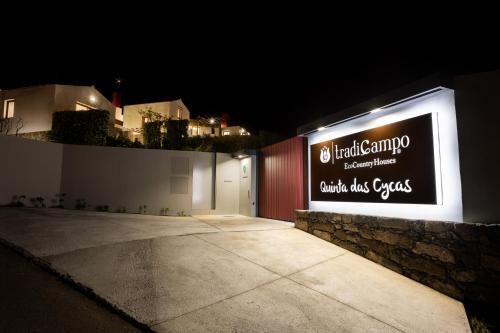 a sign on the side of a building at night at Tradicampo Eco Country Houses in Nordeste