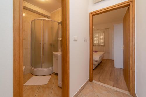 a bathroom with a shower and a toilet at Apartments Đivanović in Dubrovnik