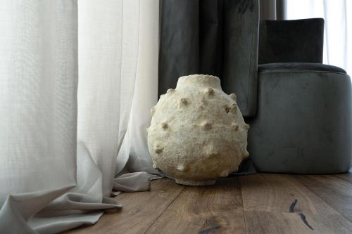 a rock sitting on the floor next to a window at PICCOLA MAESTA' boutique rooms in Civitanova Marche