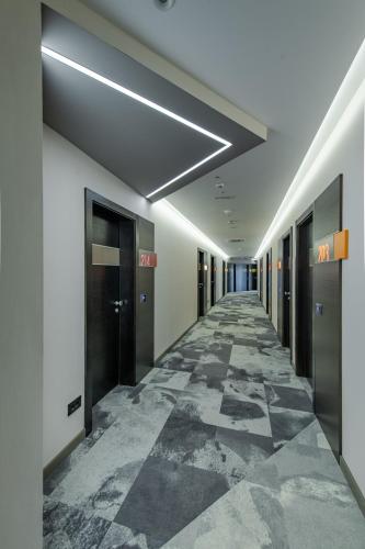 a hallway of an office building with a long corridor at Hotel Ženeva Lux in Kragujevac