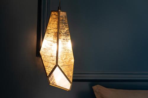 a light fixture hanging from a wall at PICCOLA MAESTA' boutique rooms in Civitanova Marche
