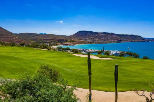 a golf course with a view of the ocean at Hotel Indigo La Paz Puerta Cortes by IHG in La Paz
