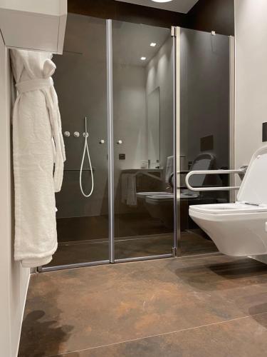 a bathroom with a shower and a toilet and a sink at PICCOLA MAESTA' boutique rooms in Civitanova Marche