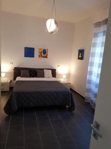 a bedroom with a bed and two tables and two lamps at Casa Nonna Anna in Maiori