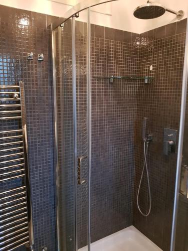 a bathroom with a shower with a glass door at Casa Nonna Anna in Maiori