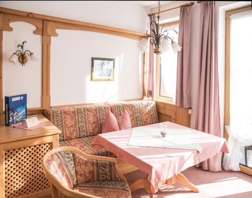 a living room with a table and a couch at Haus Feichtner in Reit im Winkl