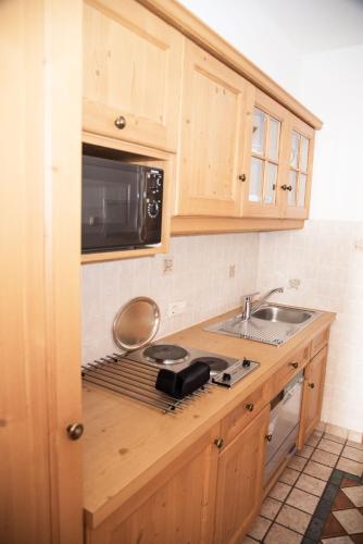 a kitchen with a sink and a microwave at Haus Feichtner in Reit im Winkl