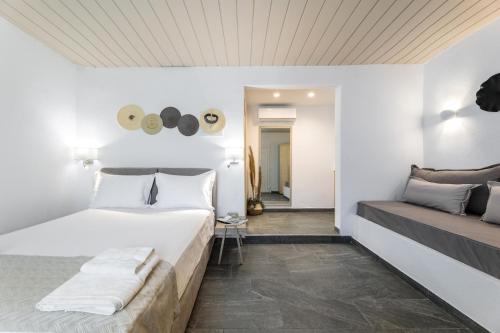 a hotel room with a bed and a couch at Bay View Suites in Ayios Nikolaos Sithonia