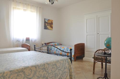 a bedroom with two beds and a couch and a window at Podere Calistri in Larciano