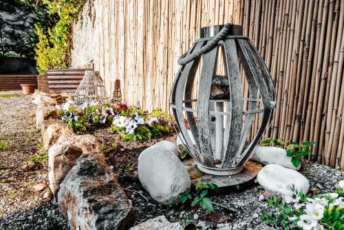 a lantern in a garden with flowers and a fence at Casa Clara in Montecchio