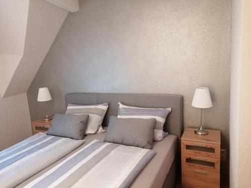 a bedroom with two beds and two night stands at Gästehaus Herbert Kappes in Zeltingen-Rachtig