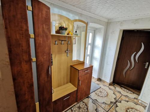 a room with a wooden cabinet and a door at Apartament Dilama Sinaia in Sinaia