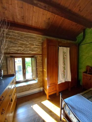 a kitchen with wooden walls and a window at CASINA LA QUERCIA in Santa Sofia