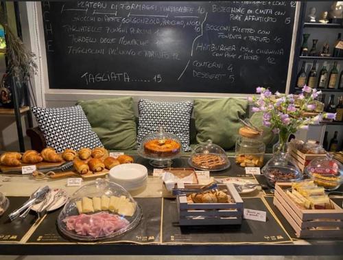 a table with different types of food on it at Locanda le Monache in Camaiore
