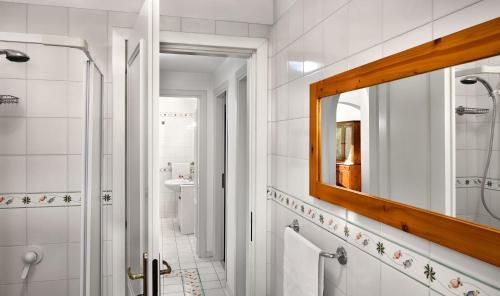 a white bathroom with a mirror and a sink at Caruso 1 - Sorrento in Sorrento