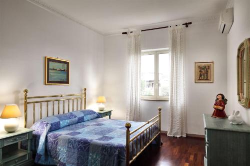 a bedroom with a bed and a window at Caruso 1 - Sorrento in Sorrento