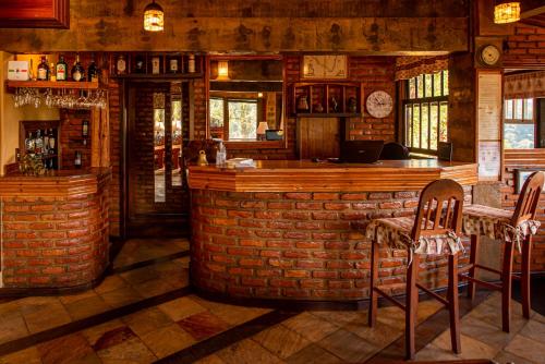 a bar in a restaurant with a brick wall at Pousada Monte Imperial in Petrópolis