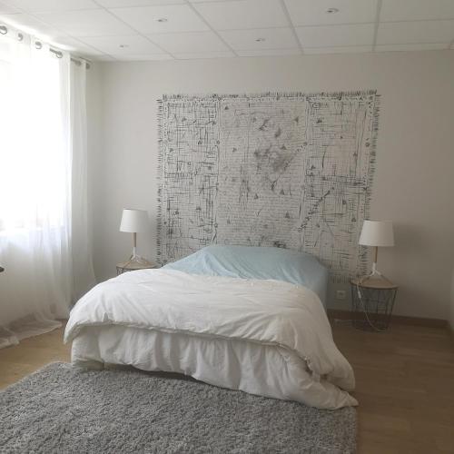 a bedroom with a bed with a large map on the wall at Logement cosy verdoyant RDC avec piscine in Charmes-sur-Rhône