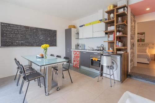 a kitchen and dining room with a table and chairs at La Casa dell'Architetto by Rent All Como in Blevio