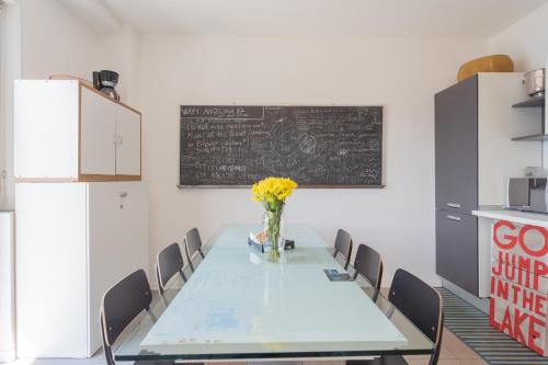 a conference room with a table with chairs and a blackboard at La Casa dell'Architetto by Rent All Como in Blevio