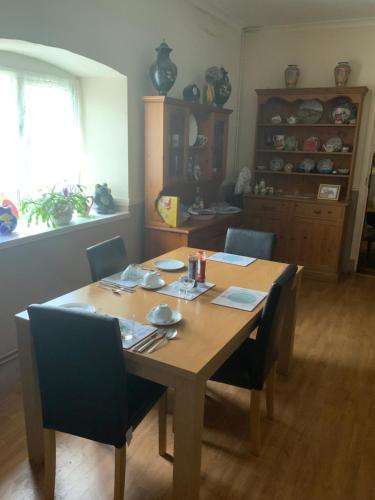 a dining room table with chairs and a wooden table at Old Gloucester Road farm bed and breakfast in Bristol