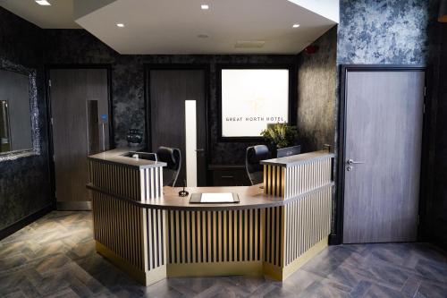 a lobby with a hair salon with a reception desk at Great North Hotel in Newcastle upon Tyne