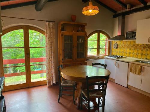 a kitchen with a table and chairs in a room at Agriturismo La Selva in Siena