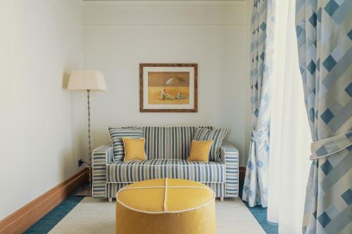 a living room with a couch and a chair at Casa Bianca Al Mare in Lido di Jesolo