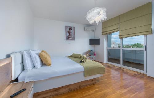 a bedroom with a bed and a large window at Villa Palma Selina in Selina