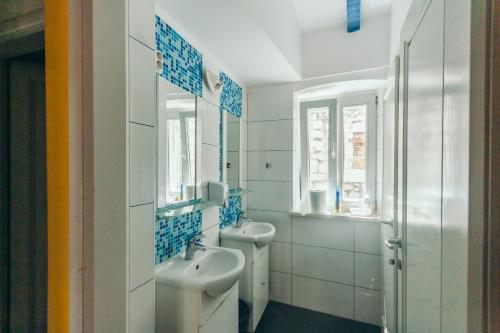 a bathroom with two sinks and a mirror at Fiesta Siesta Social Hostel in Split