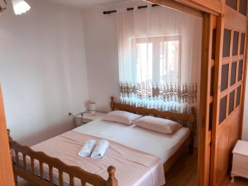 a bedroom with a bed with two towels on it at Guest house Naser in Ulcinj