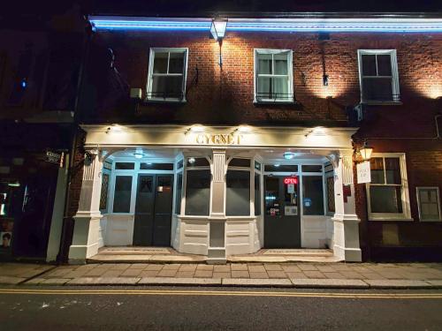 a night view of a building with a sign on it at The Swan Hotel in Hythe