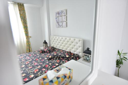 a bedroom with a bed and a mirror at FLH - Mountain View Apartment in Sibiu