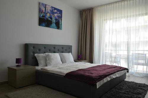 a bedroom with a large bed and a window at De Silva Residence in Mamaia