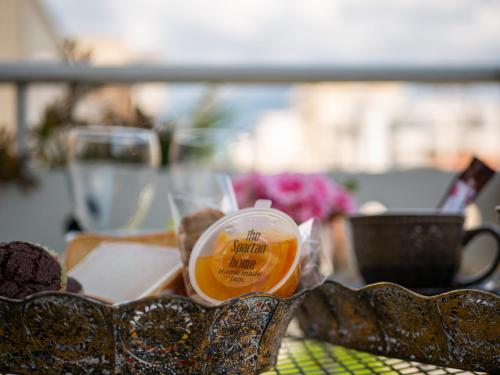 a cup of beer sitting on a table with food at Lycurgus - The Spartan Home in Sparti