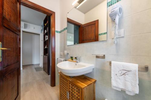 a bathroom with a sink and a mirror at Casa Vacanze Raggio di Luna in Villasimius