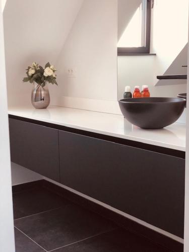 a black bowl on a counter in a kitchen at BLOC79/4 in Knokke-Heist