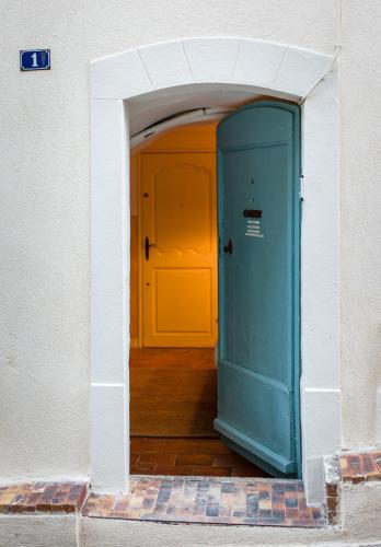 an entrance to a room with a blue door at La Grande Maison De Nans in Nans-les-Pins
