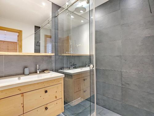 a bathroom with a shower and a sink at Square Poste 237 in Verbier