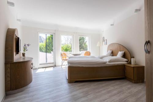 a bedroom with a bed with a person sitting on it at Muschel 2 in Ahrenshoop