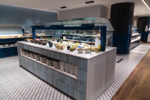 a buffet in a restaurant with food on display at Suites Plaza Hotel & Wellness in Andorra la Vella