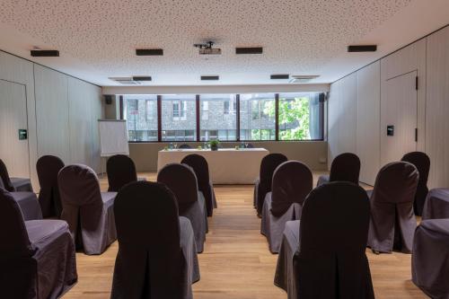 a conference room with chairs and a table in the middle at Suites Plaza Hotel & Wellness in Andorra la Vella